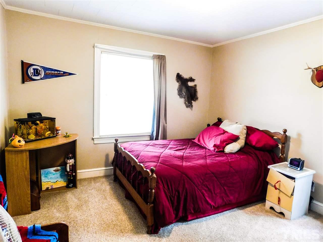 1096 Gillis Road Roxboro, NC 27574 - Photo 11 of 16 a bedroom with a bed and a dresser
