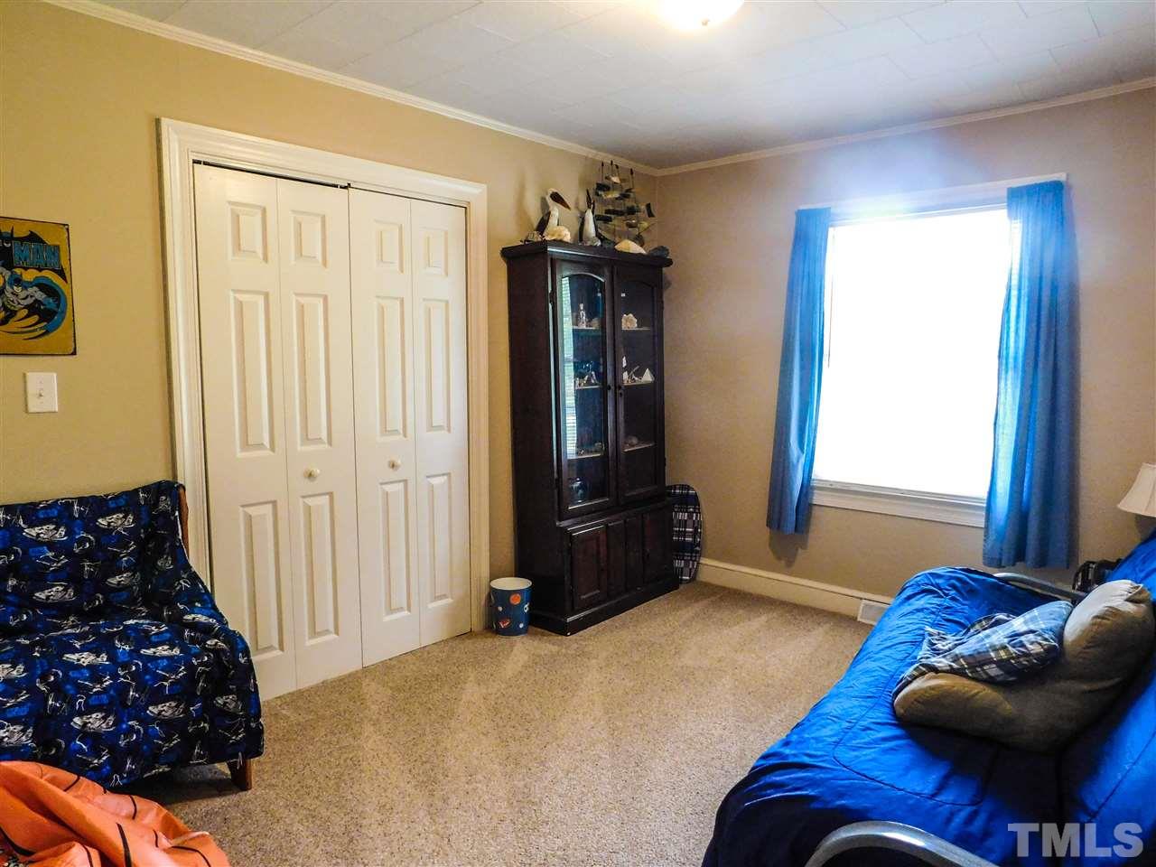 1096 Gillis Road Roxboro, NC 27574 - Photo 13 of 16 a bedroom with a bed and furniture