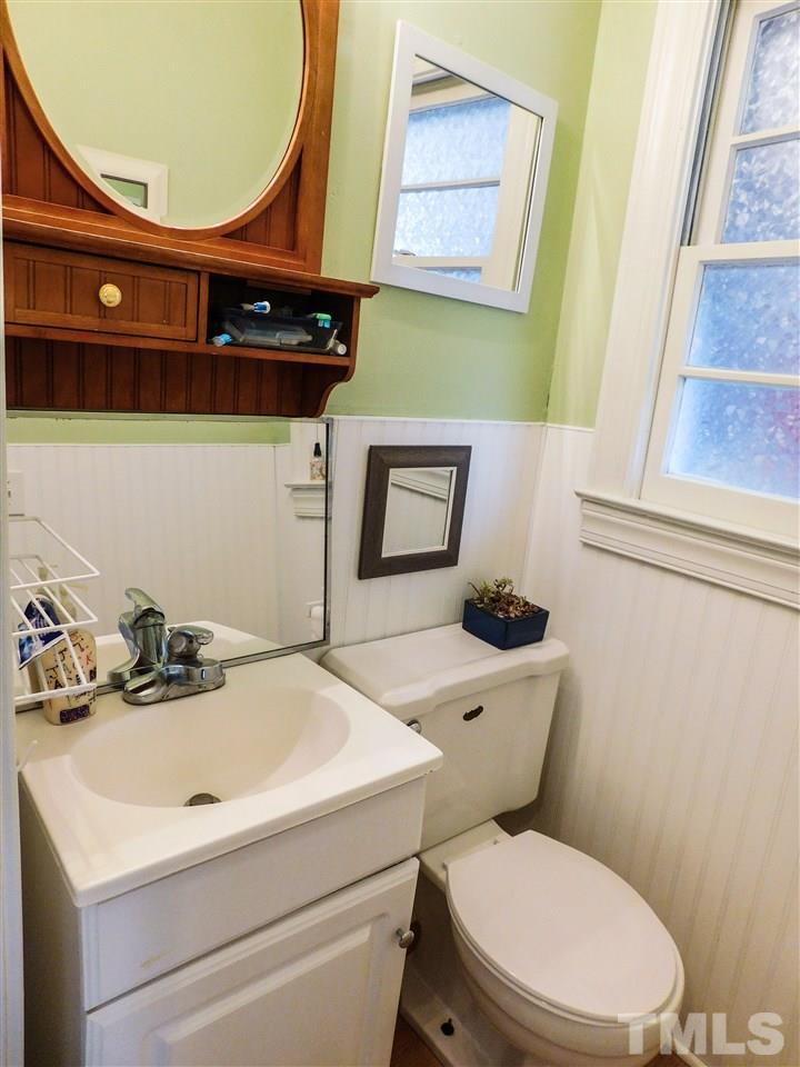 1096 Gillis Road Roxboro, NC 27574 - Photo 15 of 16 a bathroom with a sink a toilet and mirror