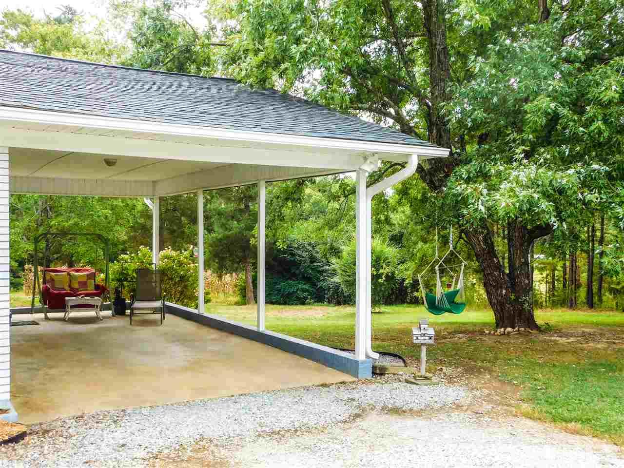 1096 Gillis Road Roxboro, NC 27574 - Photo 3 of 16 a view of a patio with a table chairs and a backyard