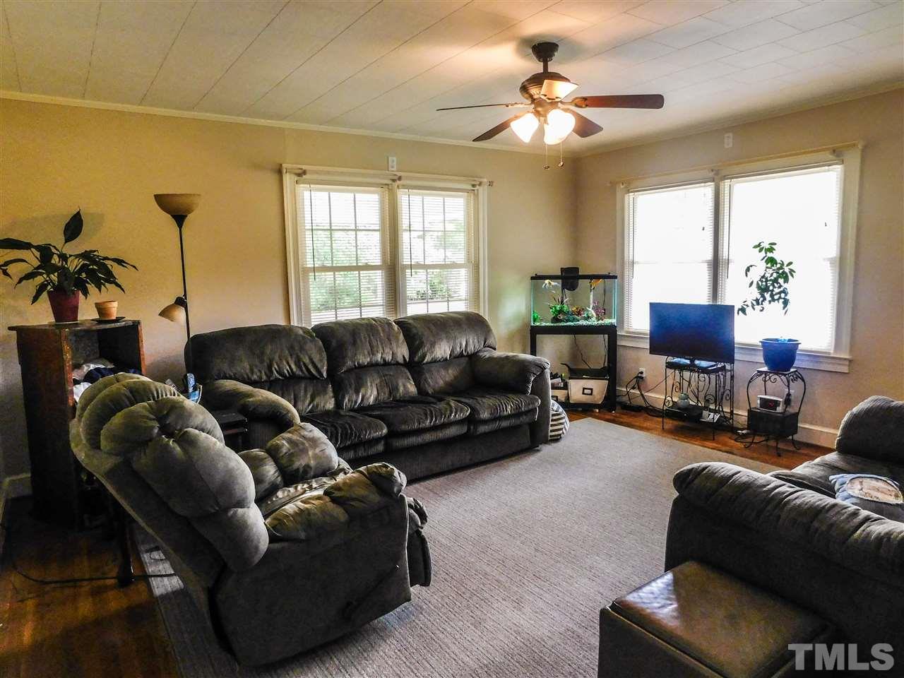 1096 Gillis Road Roxboro, NC 27574 - Photo 5 of 16 a living room with furniture a ceiling fan and a window