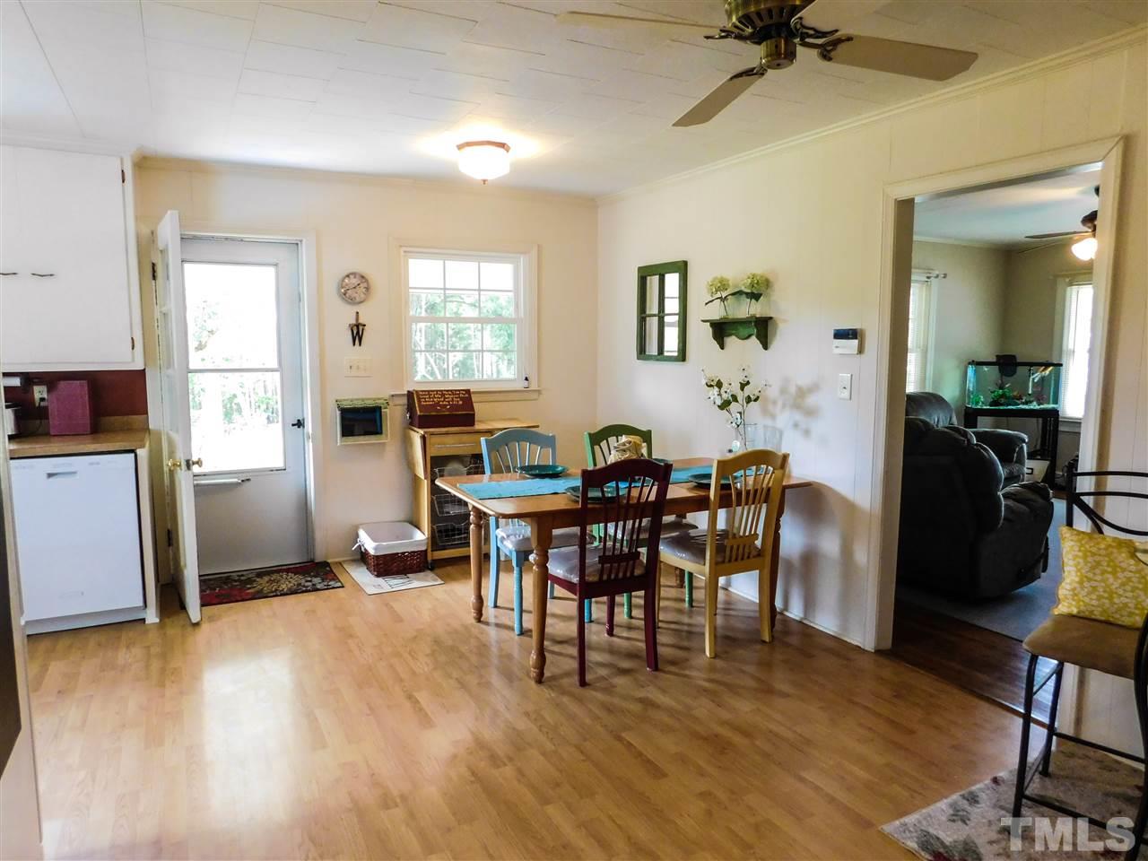1096 Gillis Road Roxboro, NC 27574 - Photo 8 of 16 a view of a dining room with furniture and wooden floor
