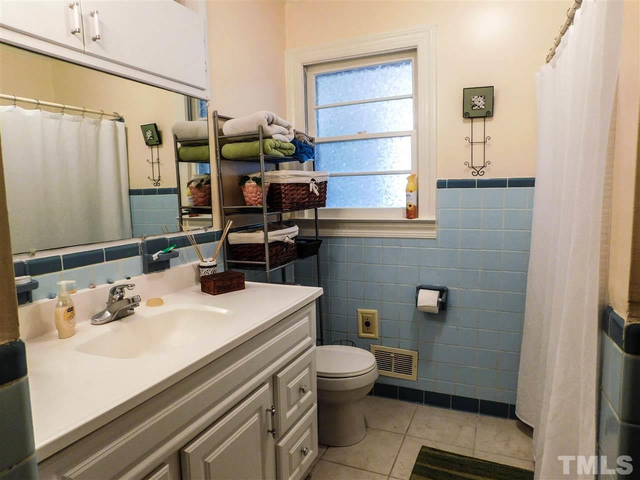 1096 Gillis Road Roxboro, NC 27574 - Photo 10 of 16 a bathroom with a sink a toilet and shower