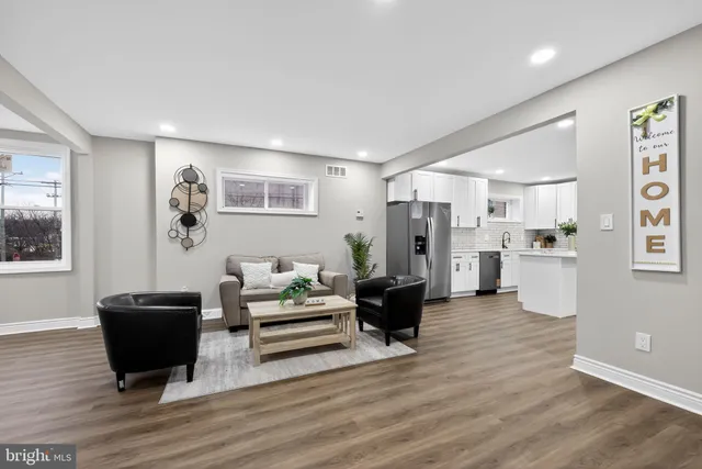 a living room with furniture and a kitchen view