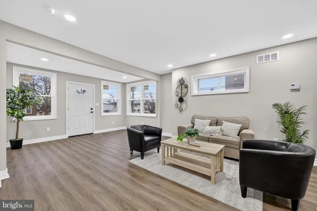 a living room with furniture and a potted plant