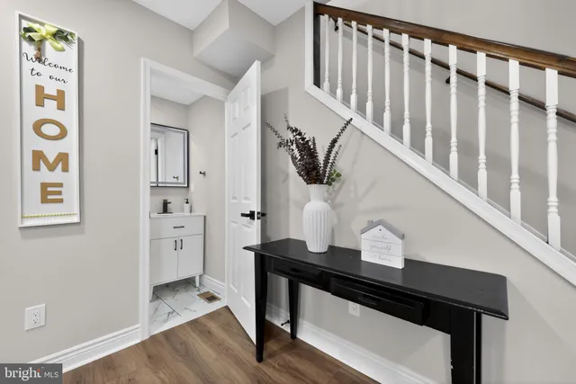 a view of entryway and hall with wooden floor