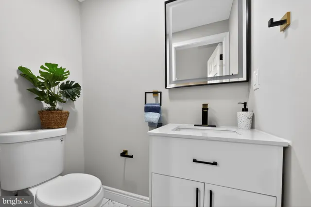 a bathroom with a toilet sink and mirror