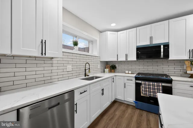 a kitchen with a sink stove and cabinets