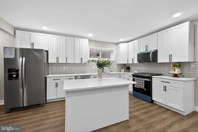 a kitchen with a refrigerator sink and microwave