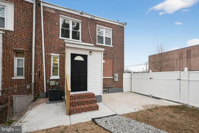 a view of a brick house with many windows