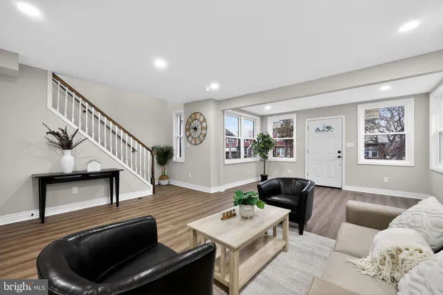 a living room with furniture and wooden floor