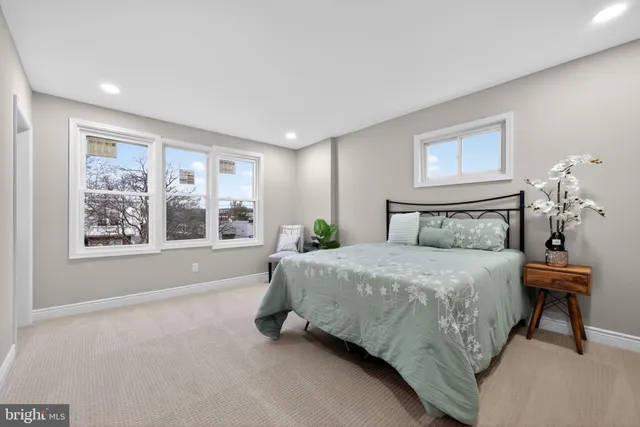 a spacious bedroom with a bed and a window