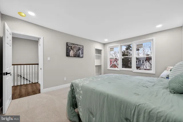 a bedroom with a large bed and a window