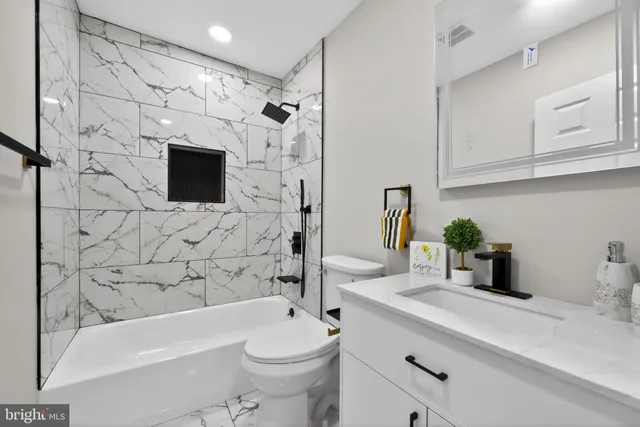 a bathroom with a sink a mirror a bathtub and shower