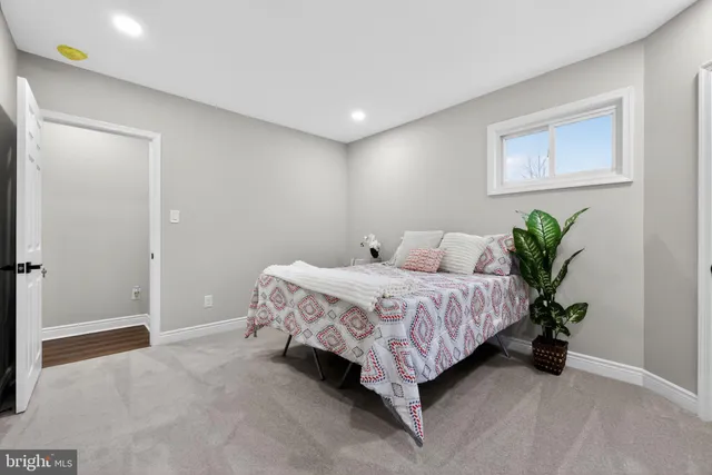 a bedroom with a bed and a potted plant