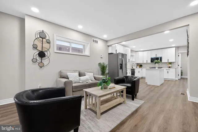 a living room with furniture and kitchen view