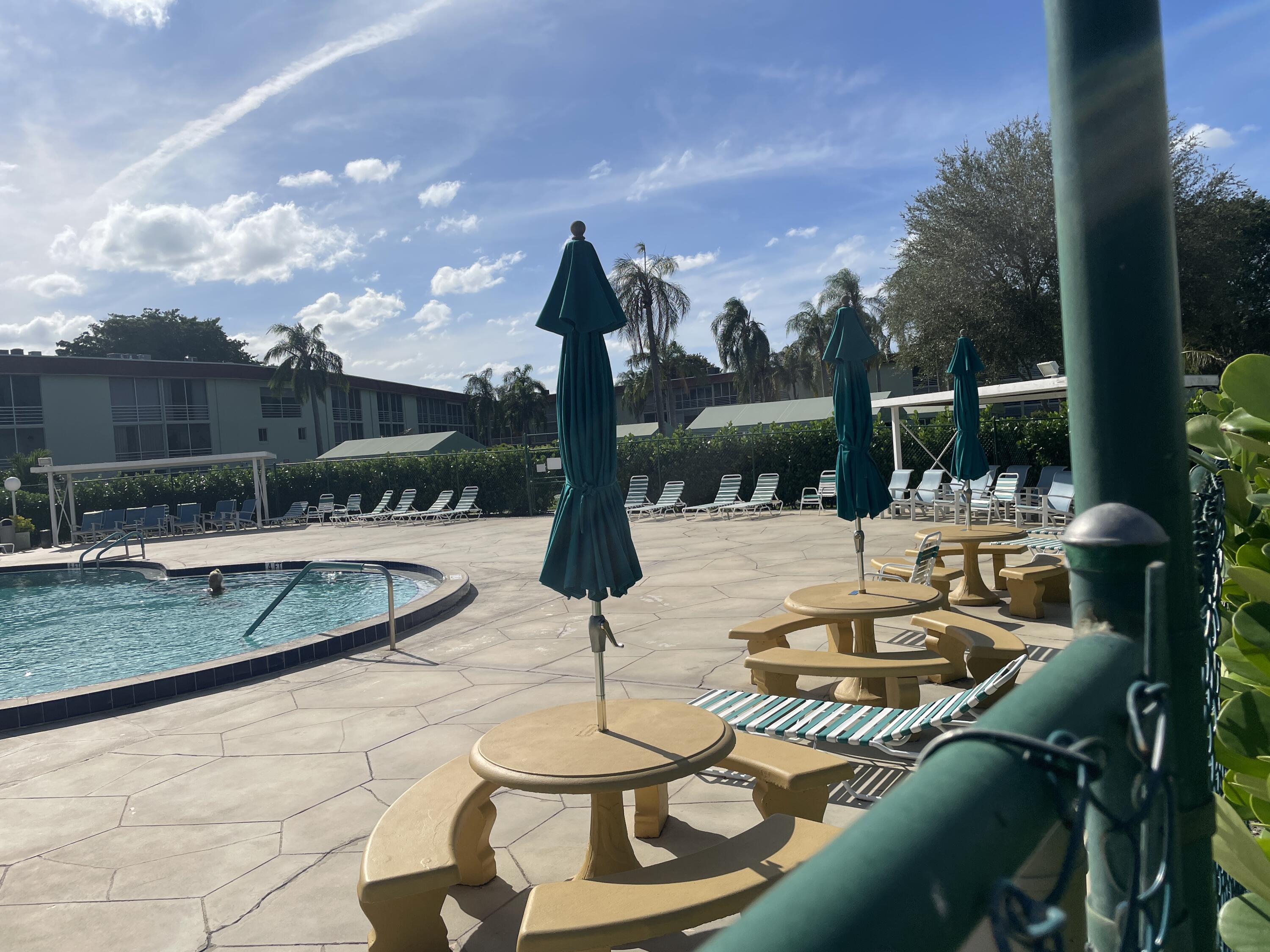 3300 Springdale Boulevard, Unit 201 Palm Springs, FL 33461 - Photo 21 of 49 a view of a swimming pool with a patio