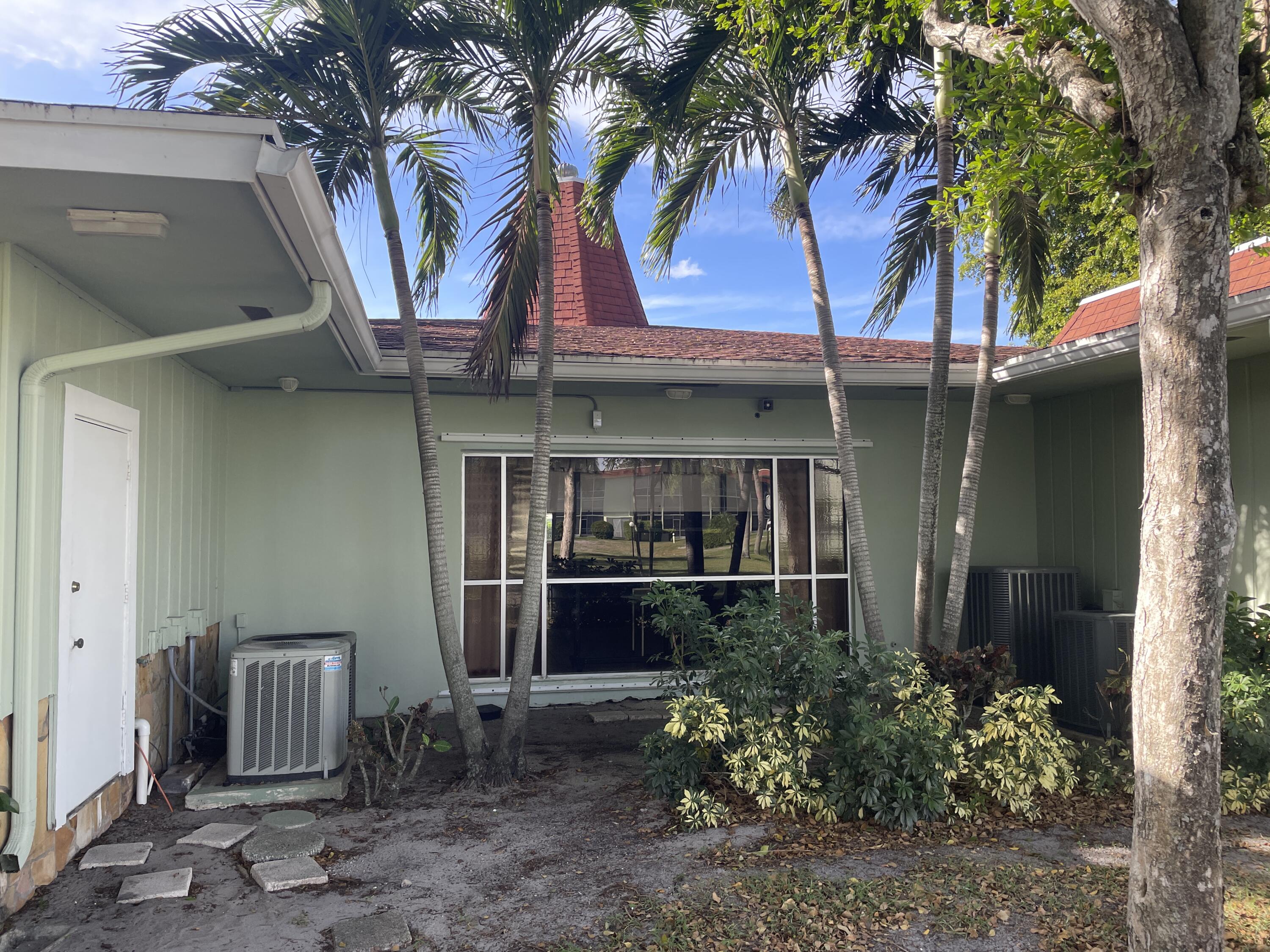 3300 Springdale Boulevard, Unit 201 Palm Springs, FL 33461 - Photo 22 of 49 a view of a house with a patio