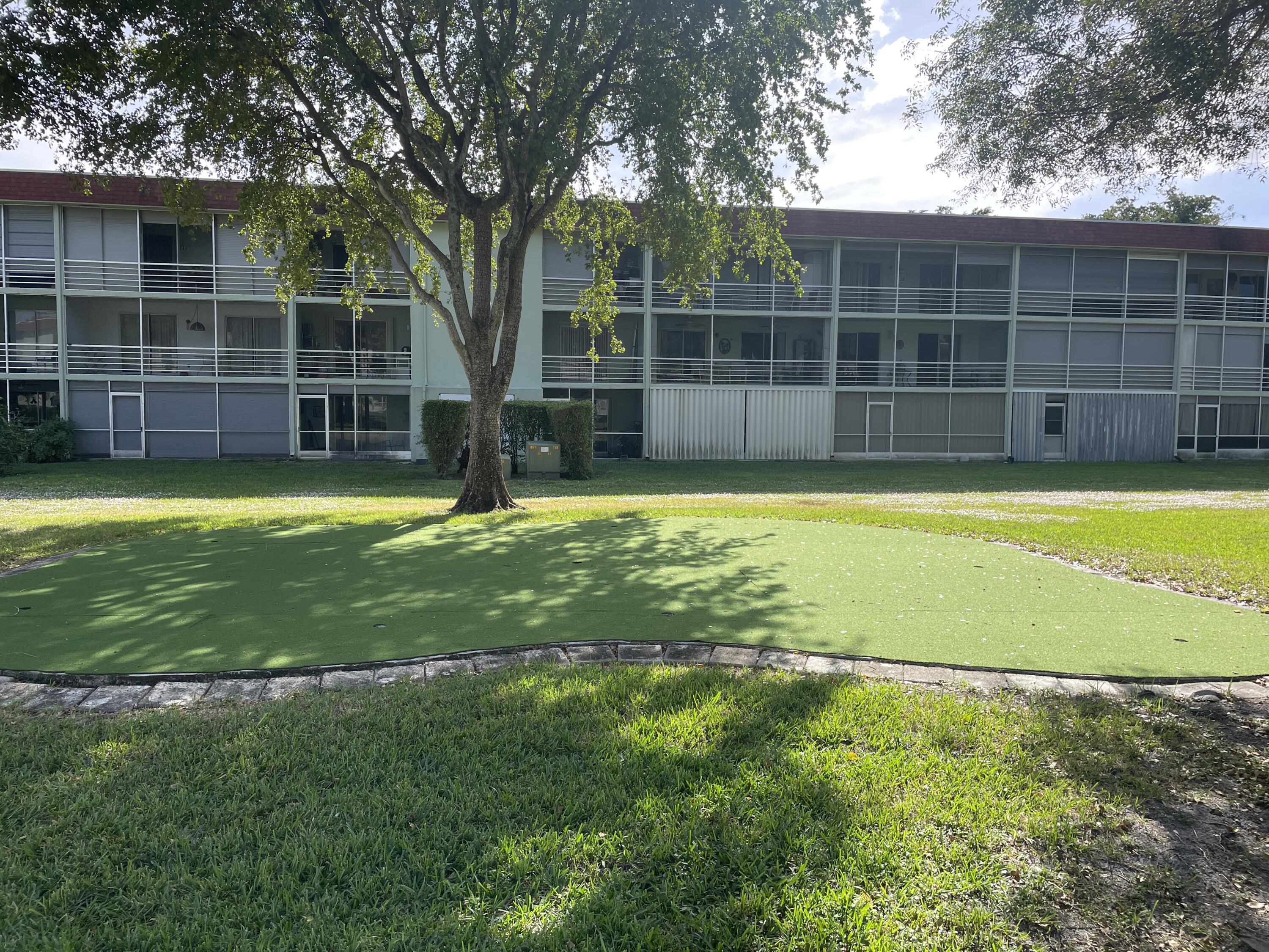 3300 Springdale Boulevard, Unit 201 Palm Springs, FL 33461 - Photo 27 of 49 a view of a large pool with large trees and a large tree