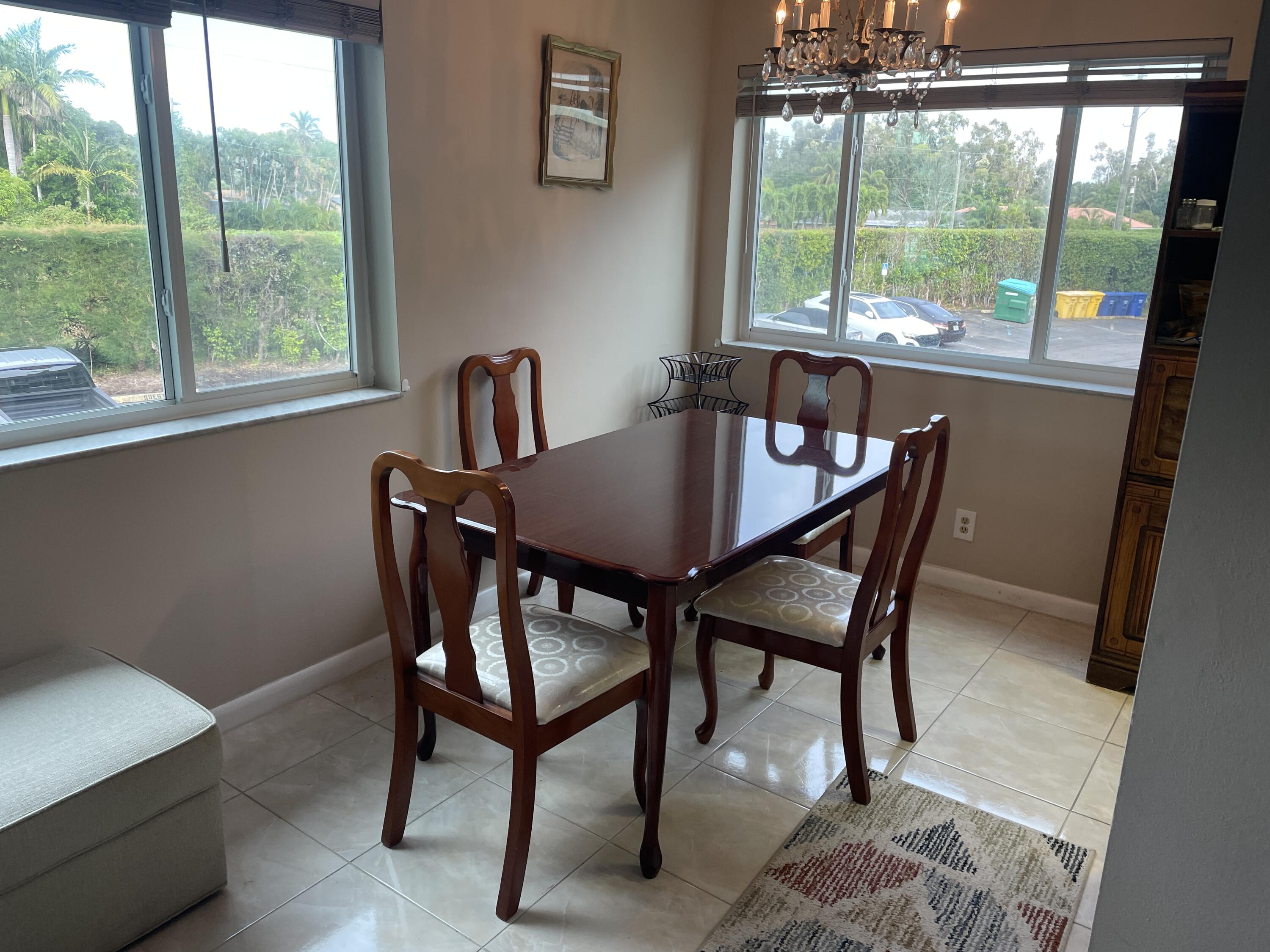 3300 Springdale Boulevard, Unit 201 Palm Springs, FL 33461 - Photo 38 of 49 a dining room with furniture and window