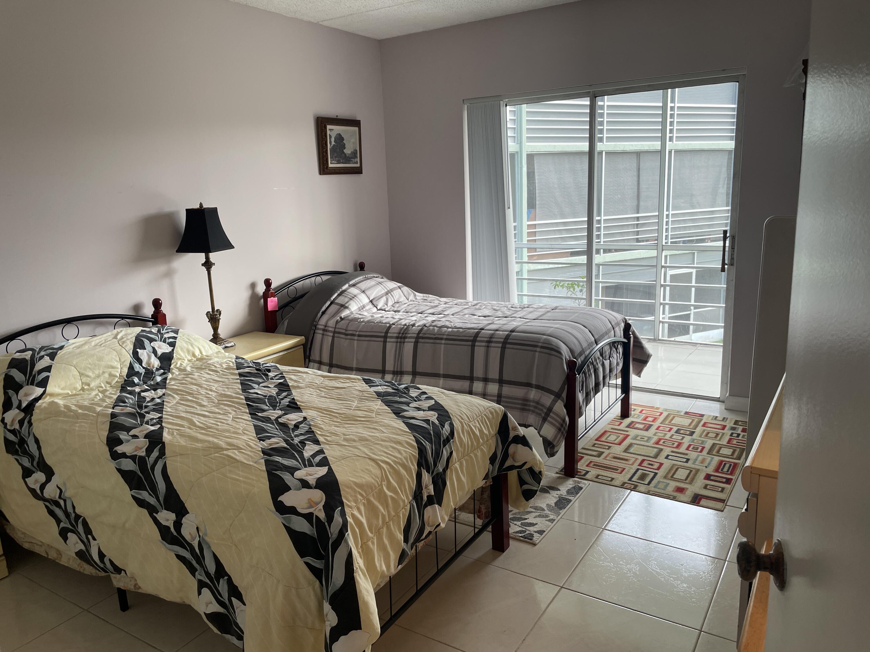 3300 Springdale Boulevard, Unit 201 Palm Springs, FL 33461 - Photo 41 of 49 a bedroom with a bed and a window