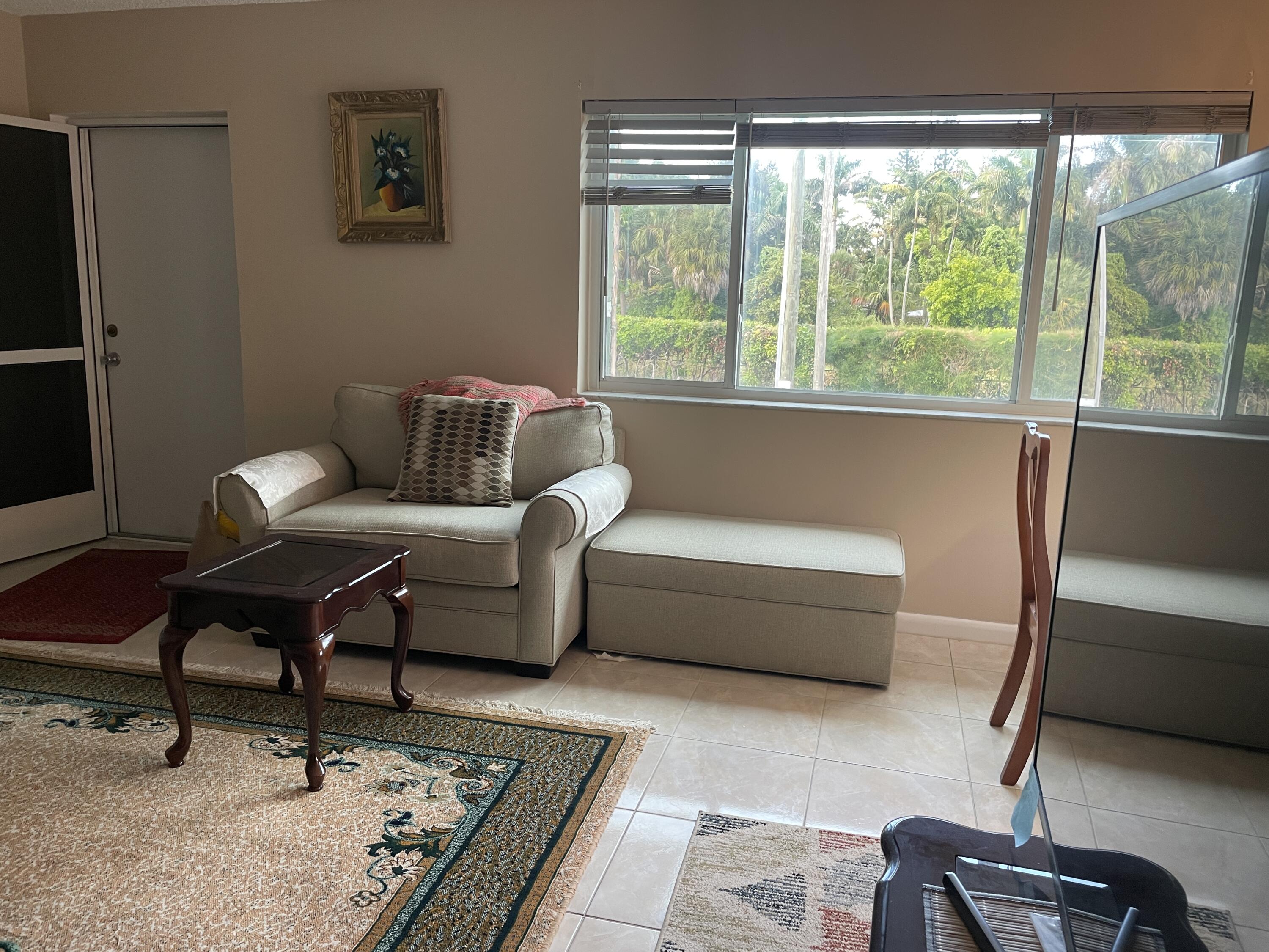 3300 Springdale Boulevard, Unit 201 Palm Springs, FL 33461 - Photo 43 of 49 a living room with furniture and a window