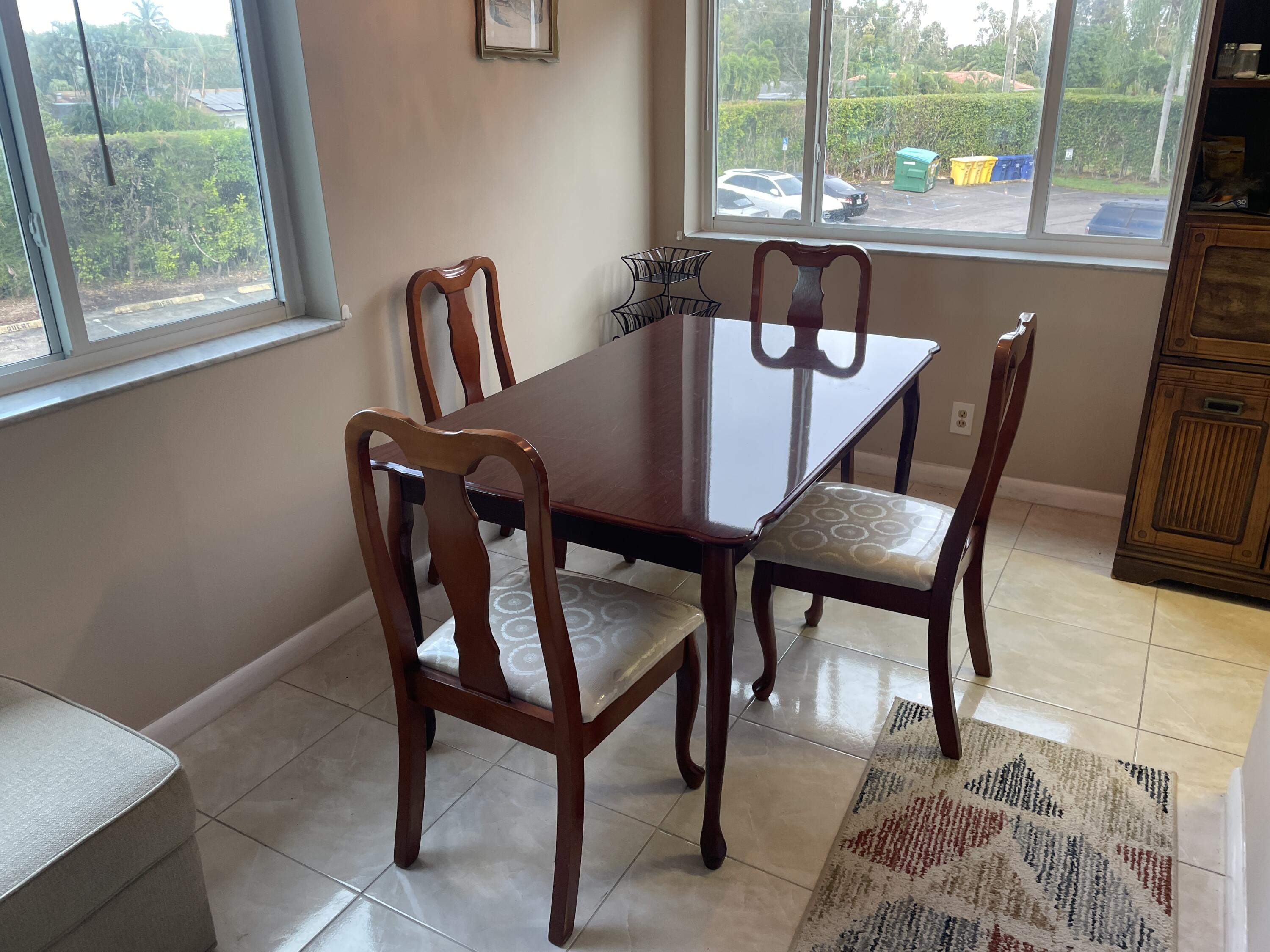 3300 Springdale Boulevard, Unit 201 Palm Springs, FL 33461 - Photo 48 of 49 a view of a dining room with furniture window and outside view