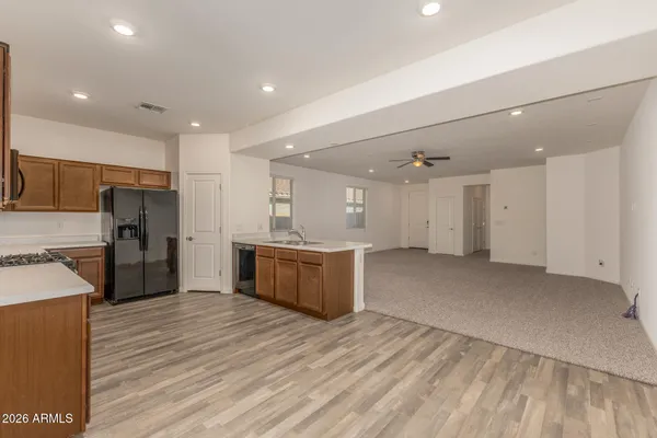 a large kitchen with kitchen island a sink stainless steel appliances and cabinets