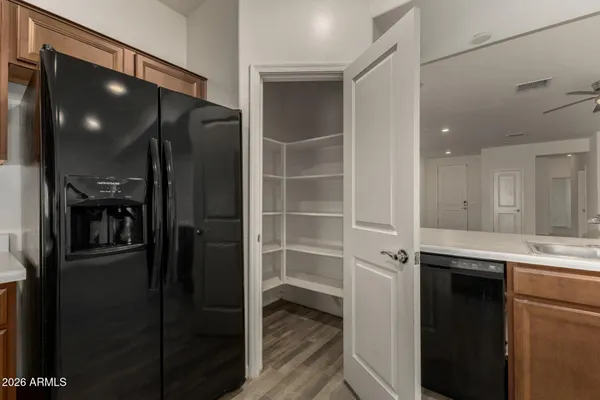 a view of a hallway with wooden floor and closet