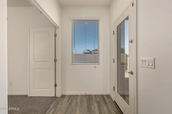 en empty room with ceiling fan and window