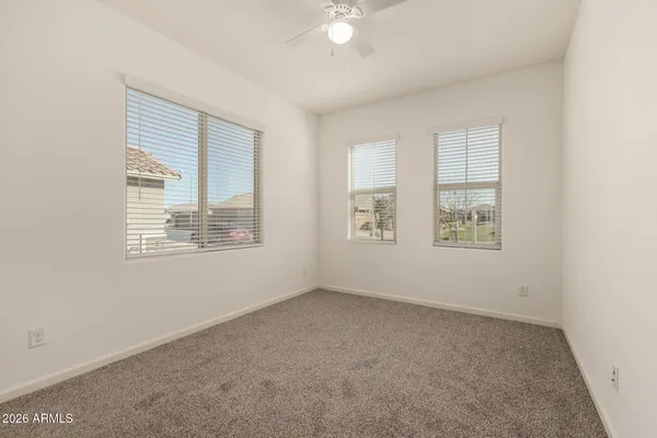 an empty room with windows and closet