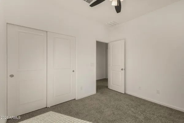 an empty room with a ceiling fan