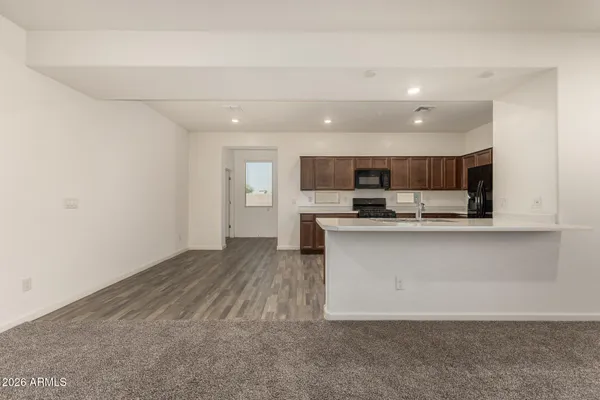 a view of kitchen with microwave and cabinets