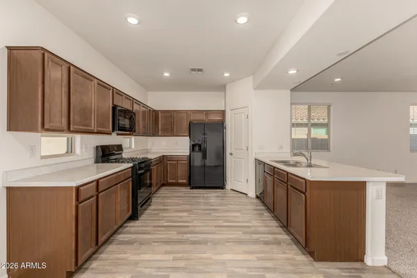 a large kitchen with stainless steel appliances lots of counter space and a sink