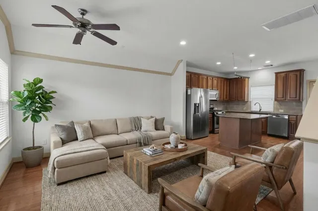 a living room with furniture and a potted plant