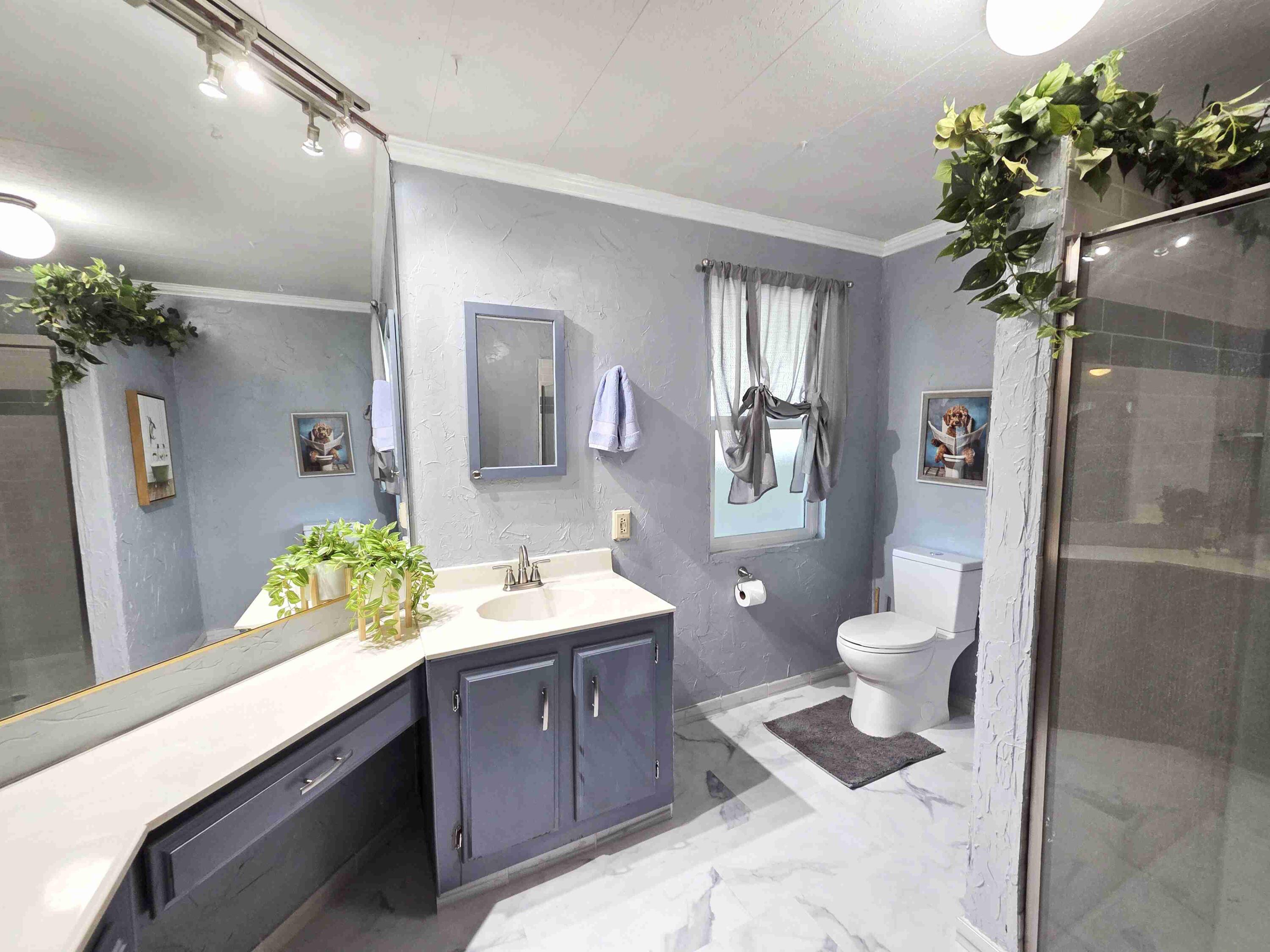 362 Buffalo Road Cathedral City, CA 92234 - Photo 15 of 15 a spacious bathroom with a granite countertop sink a toilet a mirror and shower