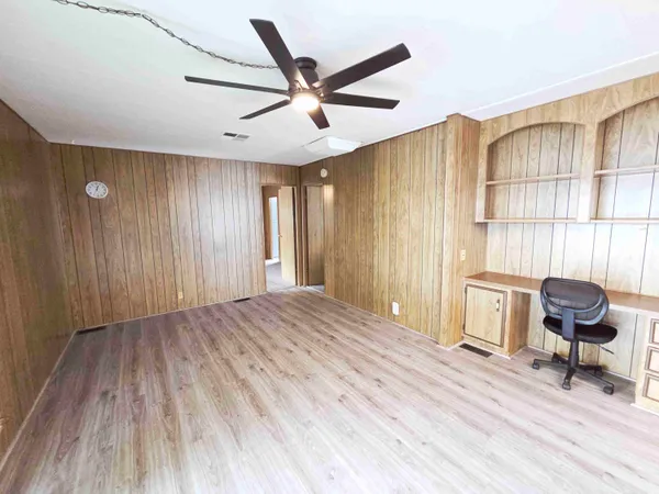 a view of a livingroom with furniture and gym equipment