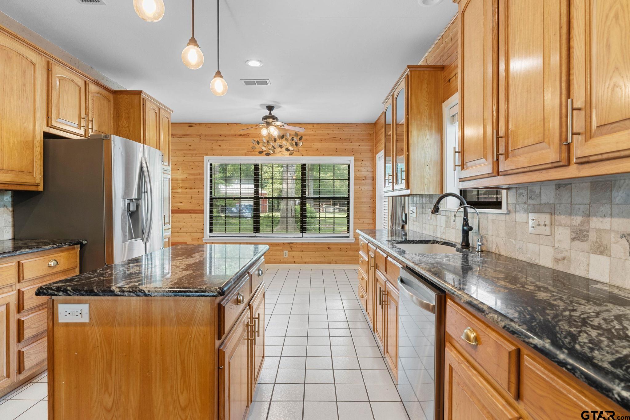 12450 County Road 420 Tyler, TX 75704 - Photo 13 of 48 a kitchen with stainless steel appliances granite countertop a sink and a refrigerator