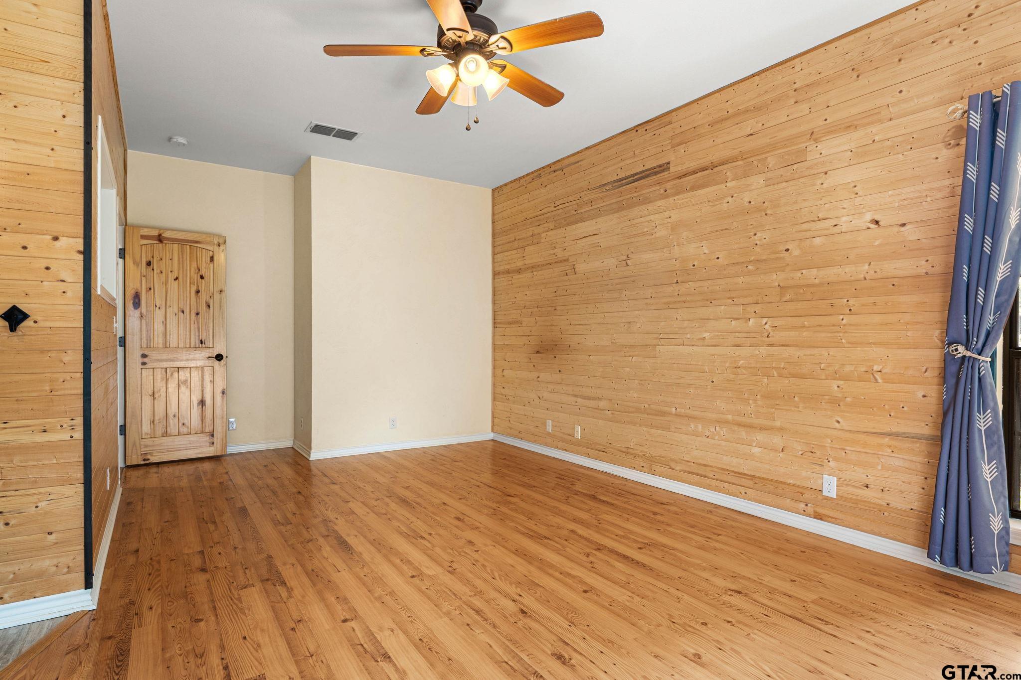 12450 County Road 420 Tyler, TX 75704 - Photo 22 of 48 a view of empty room with wooden floor and fan