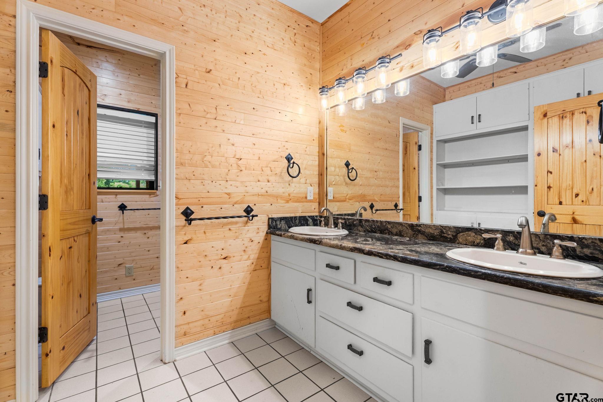 12450 County Road 420 Tyler, TX 75704 - Photo 25 of 48 a bathroom with a granite countertop sink mirror and