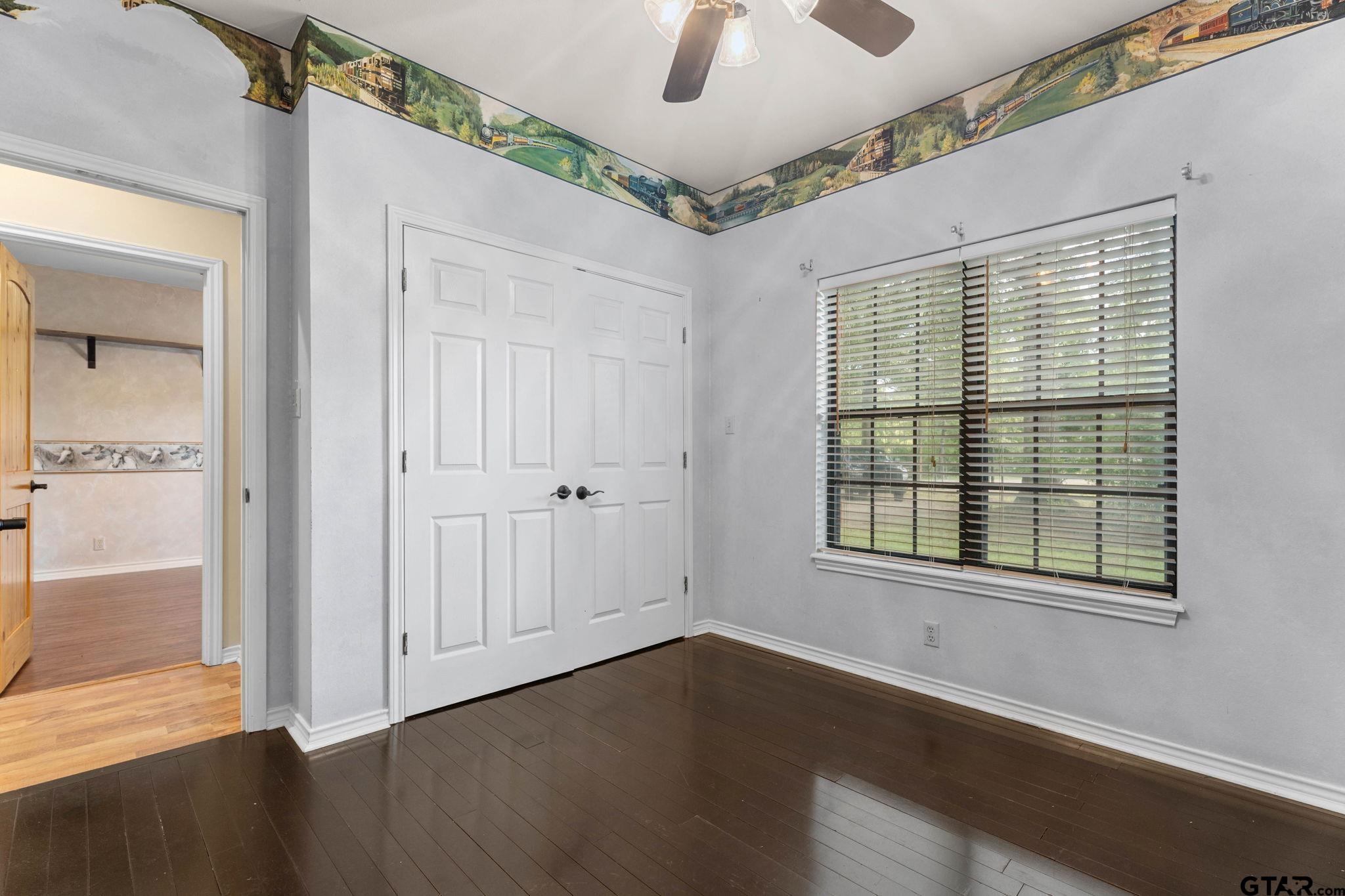 12450 County Road 420 Tyler, TX 75704 - Photo 28 of 48 an empty room with wooden floor cabinet and windows