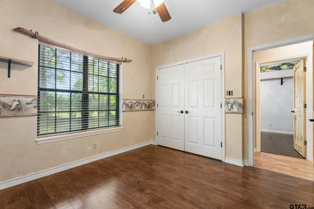 an empty room with wooden floor and a window