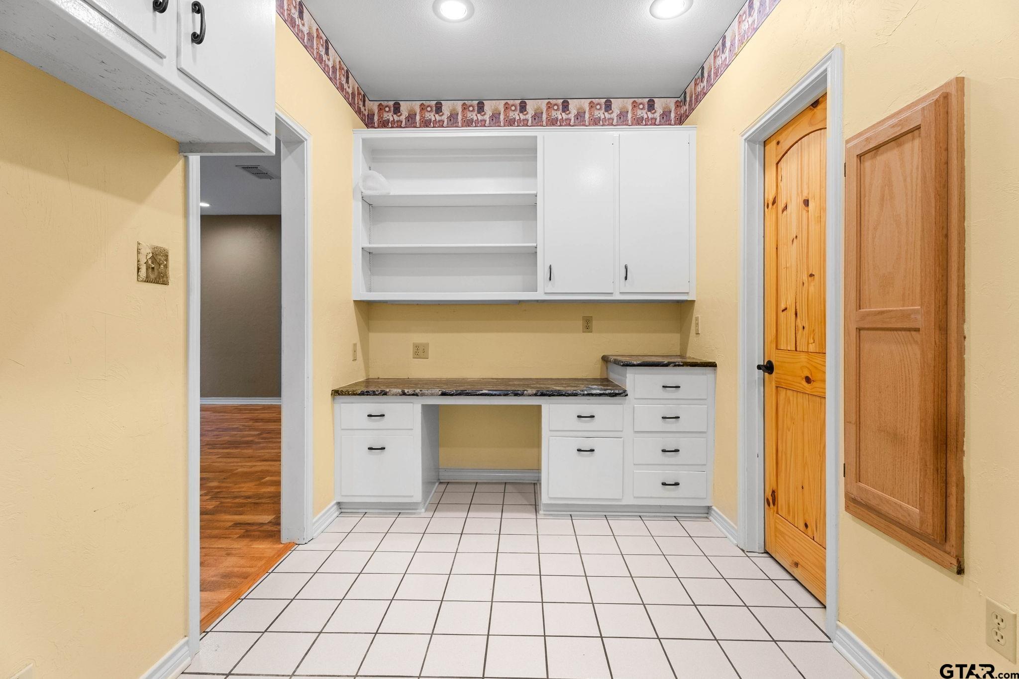 12450 County Road 420 Tyler, TX 75704 - Photo 35 of 48 a kitchen with white cabinets and white appliances