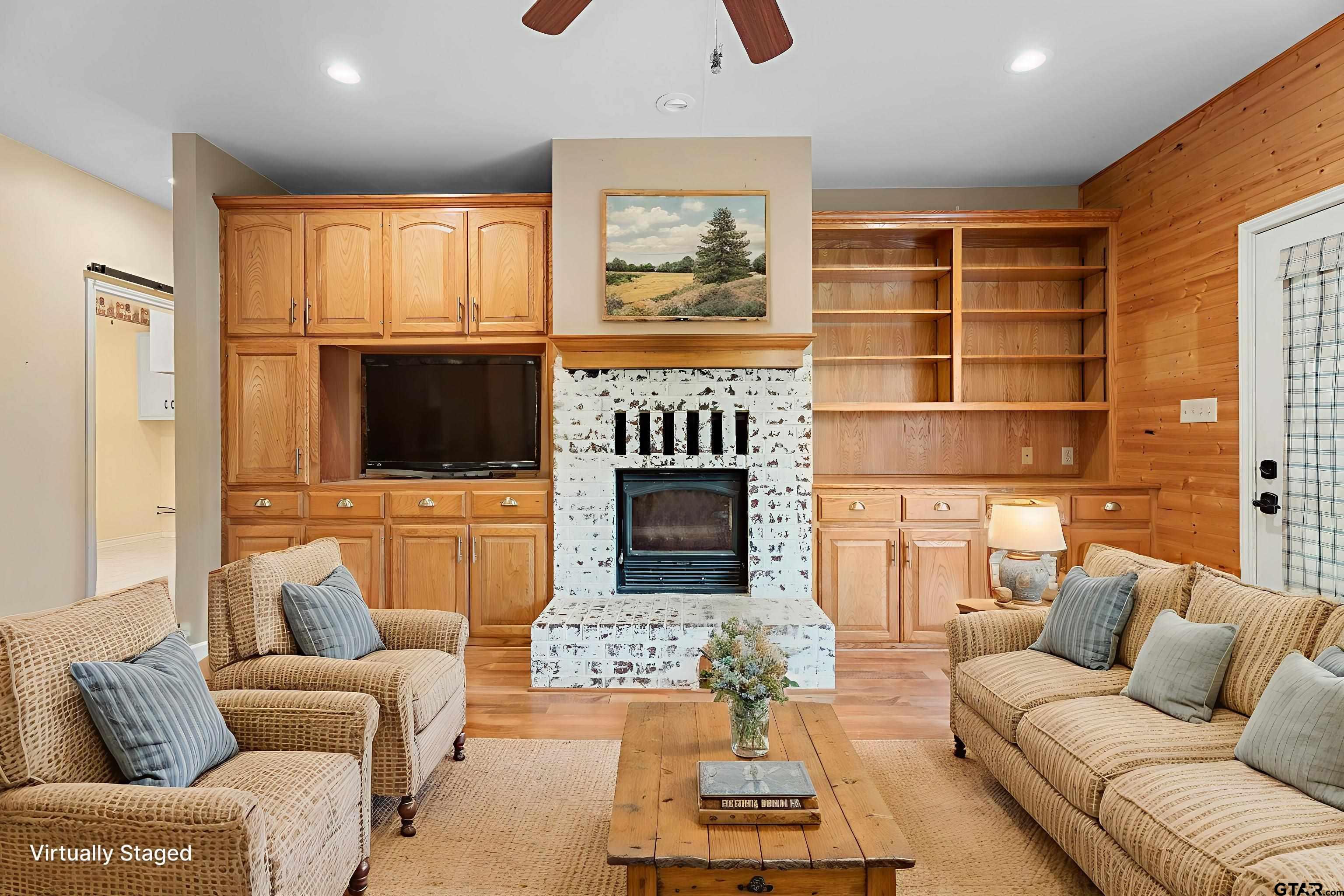 12450 County Road 420 Tyler, TX 75704 - Photo 10 of 48 a living room with furniture a fireplace and a flat screen tv