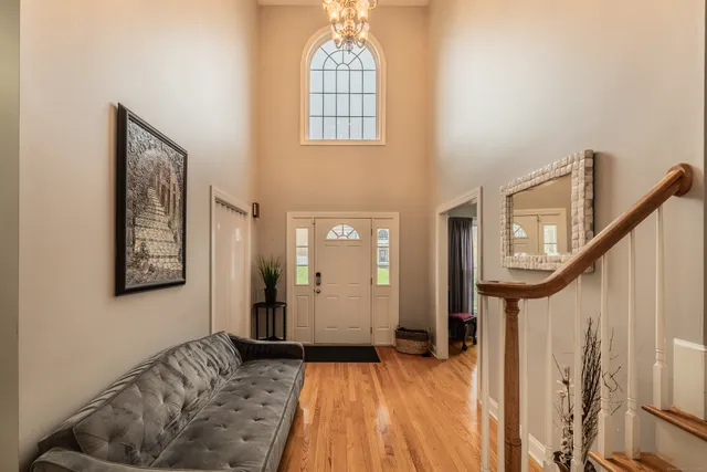 a view of a livingroom with wooden floor and stairs