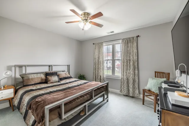 a bedroom with a bed and a chandelier