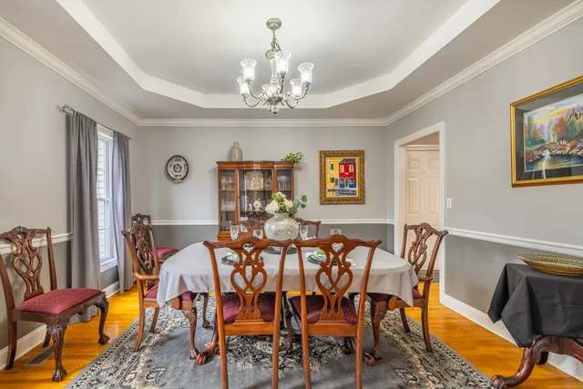a view of a dining room with furniture and chandelier