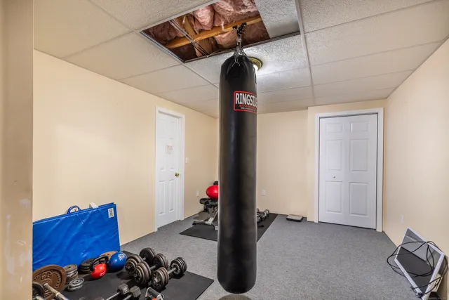 a view of kids room with toys and a ceiling fan