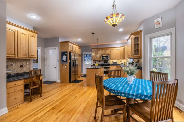 a view of a dining room with furniture window and wooden floor