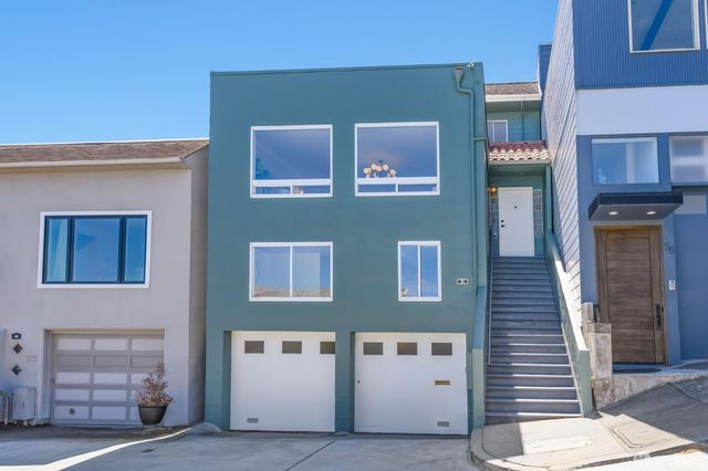 a living room with furniture chandelier and fireplace